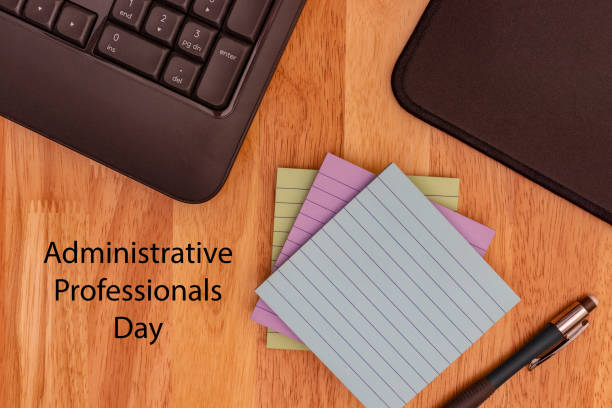 istock Administrative Professionals Day, Secretaries Day concept showing computer keyboard, mouse mat, sticky notes and pencil 1388488334