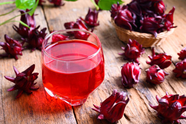 Roselle juice on wooden background, herbal organic tea for good healthy stock photo