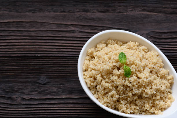 istock Bowl of boiled quinoa on wood background 1388488492