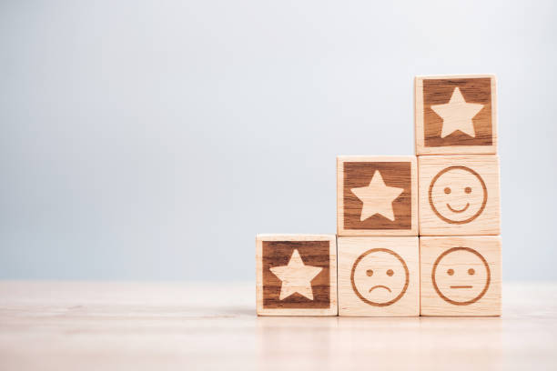 istock emotion face and Star symbol blocks on table background. Service rating, ranking, customer review, satisfaction, evaluation and feedback concept 1388489458