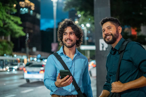 istock Businesspeople chatting while waiting for app car 1388489697