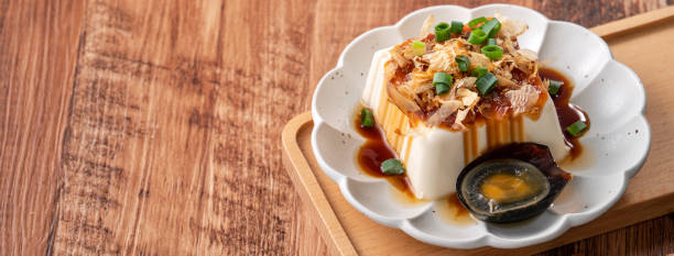 Delicious Chilled tofu and century egg with soy sauce and bonito flakes.