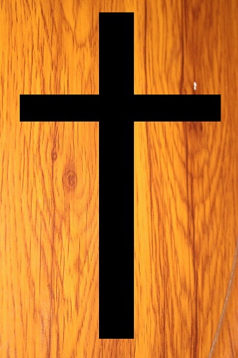chirstian cross symbol with wooden background.