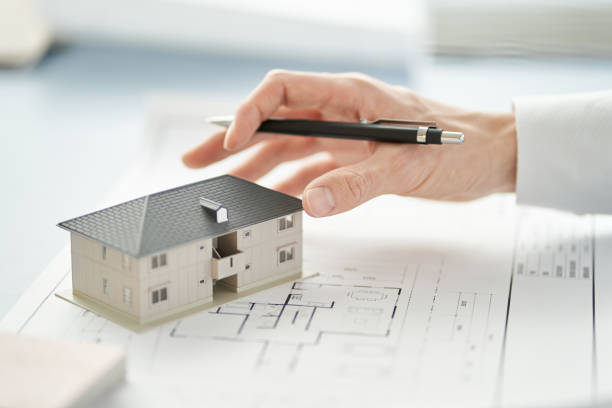 Asian architect writing on building drawings stock photo