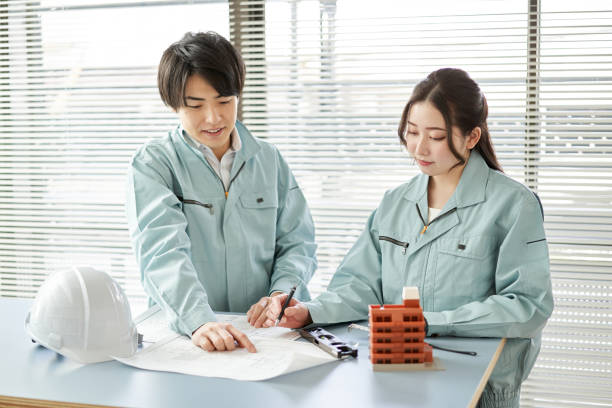 Asian workers having an architectural meeting stock photo