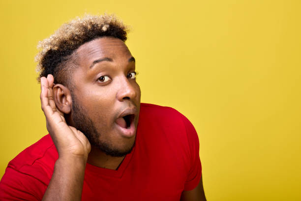 istock A dark-skinned surprised guy leaned forward leaning his hand against his ear 1388498606