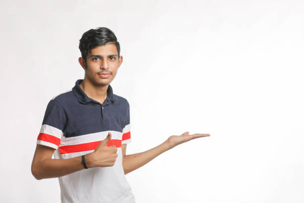 istock Young indian man giving expression with hand over white background. 1388499785