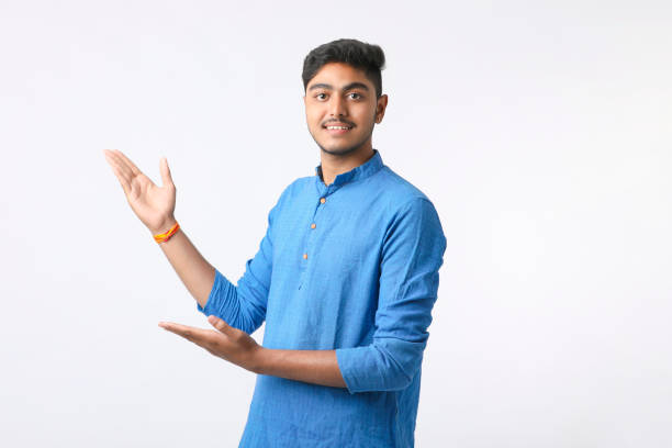 istock Indian man in tradition wear and giving expression on white background. 1388499916