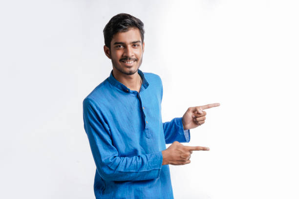 istock Indian man in tradition wear and giving expression on white background. 1388500680