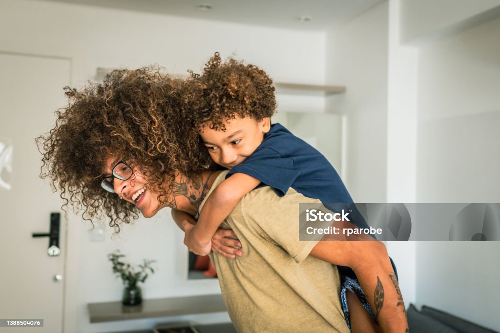 Non-binary person playing with child Non-Binary Gender Stock Photo