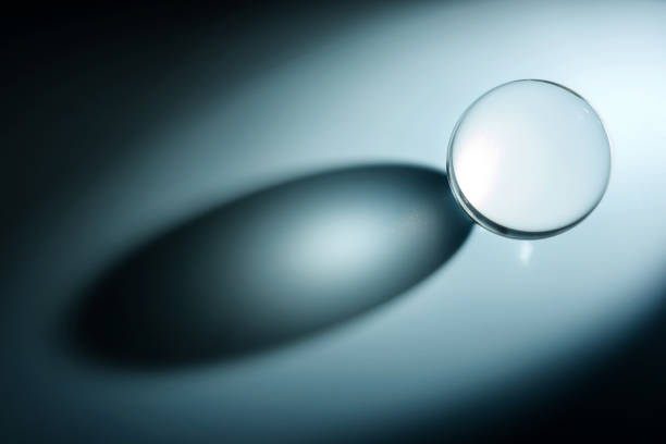 istock Composition with glass ball and shadow. Transparent ball with selective focus. 1388505104