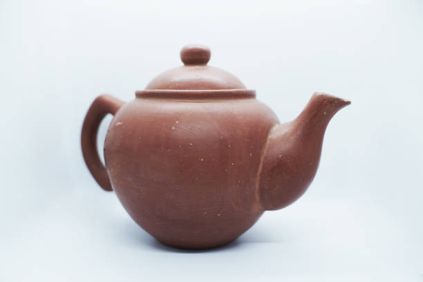 istock brown teapot isolated background. traditional home living object 1388506023