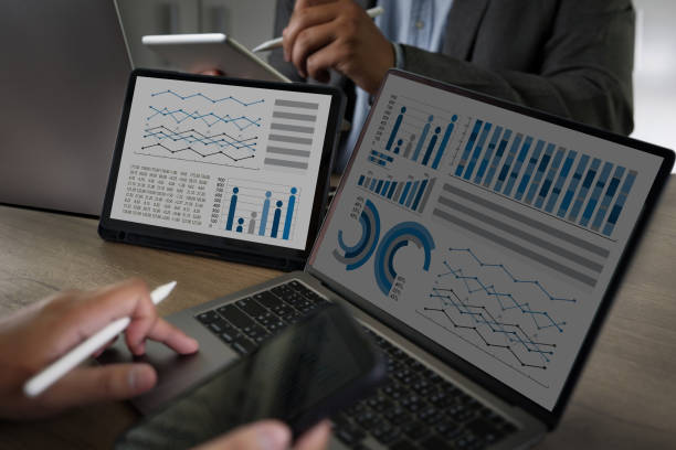 istock Two Businessman data analysis profit on the computer screen analyzing data marketing planning finance sales data 1388508577