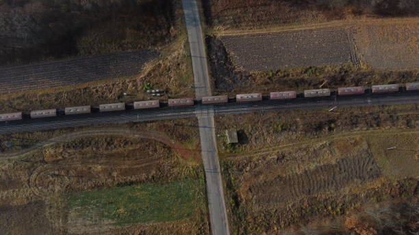 istock Top View Freight Train Passing Railway Crossing. Aerial Drone View Flight Over 1388509659