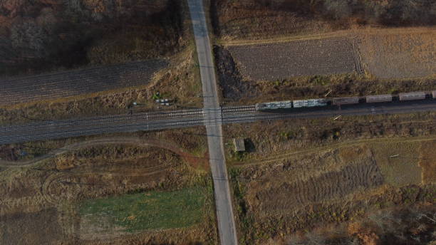 istock Top View Freight Train Passing Railway Crossing. Aerial Drone View Flight Over 1388509660