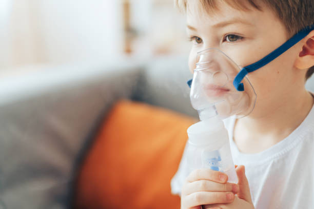 istock Little boy in mask from nebulizer close-up 1388510028