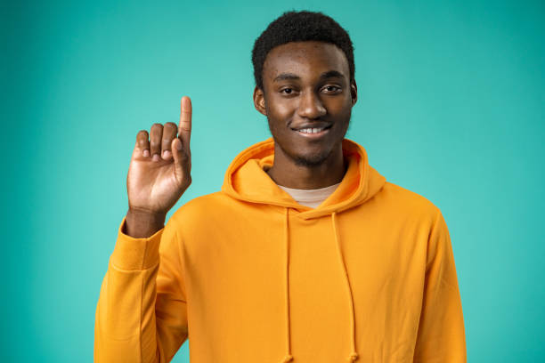 istock Happy African American man pointing finger at copy space 1388512919