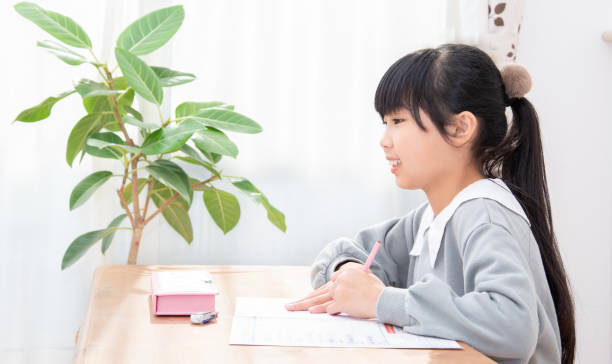 istock Japanese elementary school students doing homework in the living room 1388514099