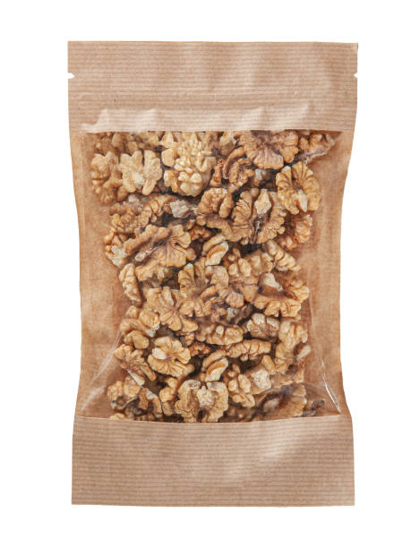 istock Peeled walnut in craft paper zip bag. Isolate. White background. 1388514260
