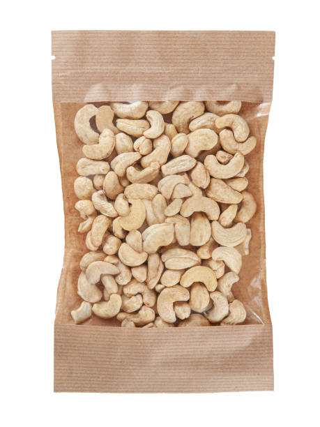 istock Cashew nuts in a craft paper zip bag. Isolate. White background. 1388514284