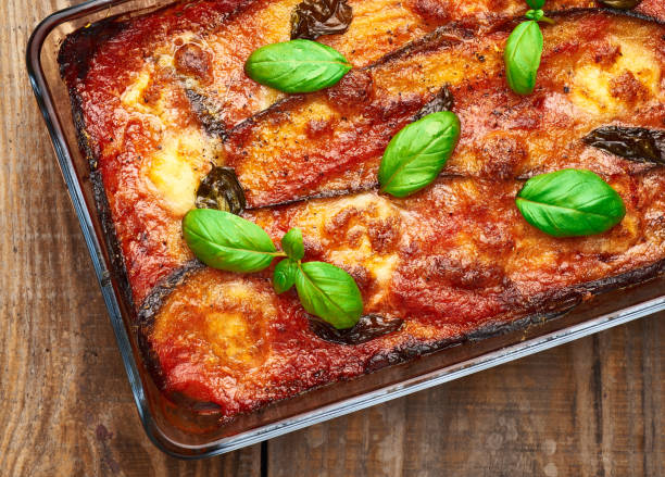 istock Eggplant parmigiana on rustic wooden table. 1388516625