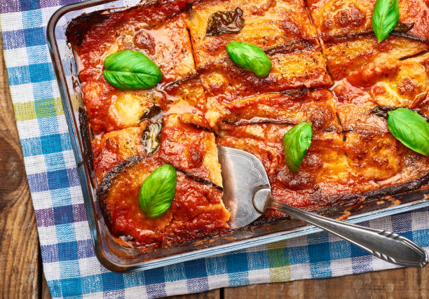 istock Eggplant parmigiana on rustic wooden table. 1388516647
