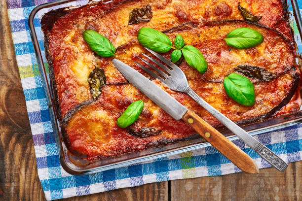 istock Eggplant parmigiana on rustic wooden table. 1388516791