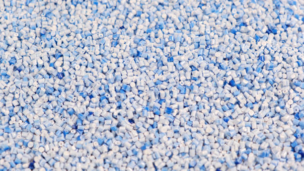 istock Secondary granule made of polypropylene, Blue Plastic pellets crumbles to the table. Plastic raw materials in granules for industry. Polymer resin. Raw plastic recycling concept 1388517745