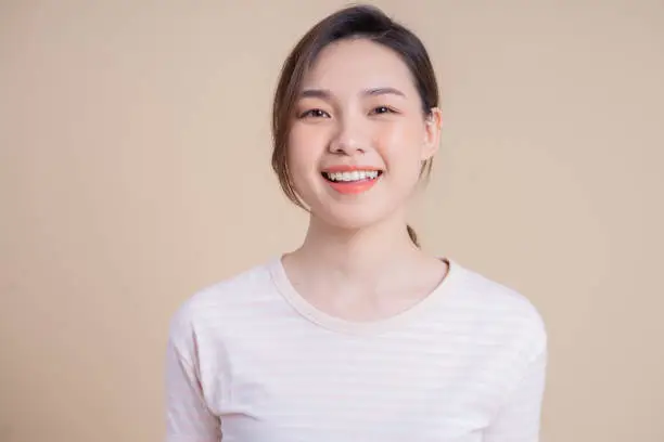 Photo of Portrait of young Asian girl posing on background