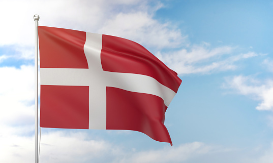 Denmark flag waving on the flagpole on a sky background