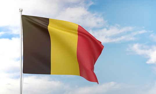 Belgian flag waving in the blue sky. Politics and Government Concept.