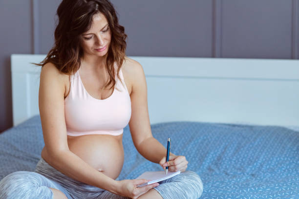 istock Pregnant women writing a list 1388525542