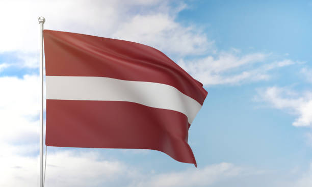 istock Latvia flag waving in the blue sky. 1388526824