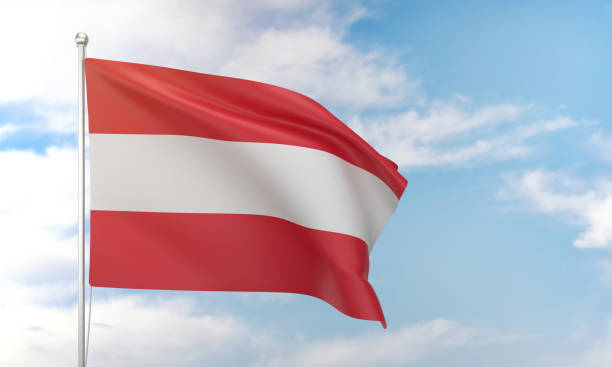австрийский флаг развевается в голубом небе. - austrian flag стоковые фото и изображения
