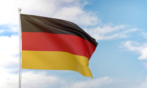 German flag waving in the blue sky. Politics and Government Concept.