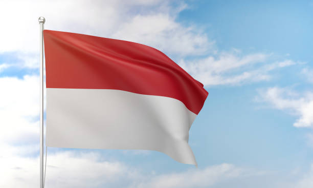 istock Monaco flag waving in the blue sky. 1388526935