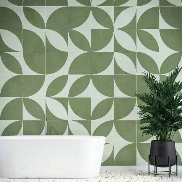 Luxury modern bathroom interior with a self-standing bathtub and potted plant (howea forsteriana) on terrazzo floor, in front of an empty white and khaki green geometric shape tiled wall background with copy space. 3D rendered retro 80's style image.