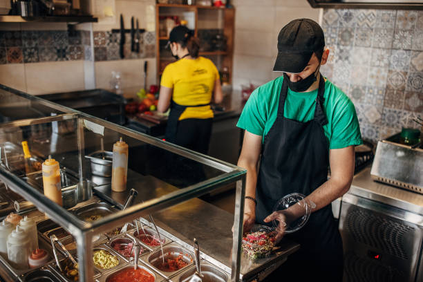 istock Male chef preparing salad 1388528325