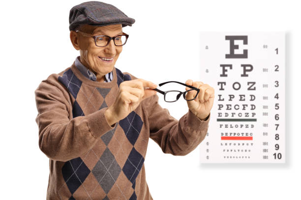 istock Elderly man trying on eyeglasses in front of a vision test 1388528473