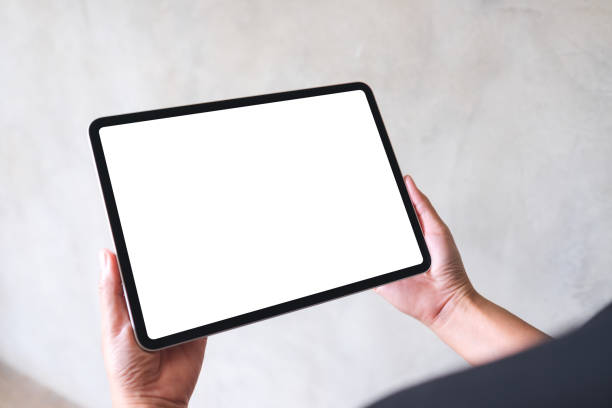 istock Mockup image of a woman holding digital tablet with blank white desktop screen 1388529448