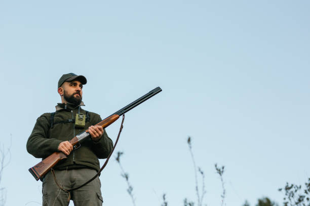 istock Male hunter holding a shotgun while searching for prey. 1388529652