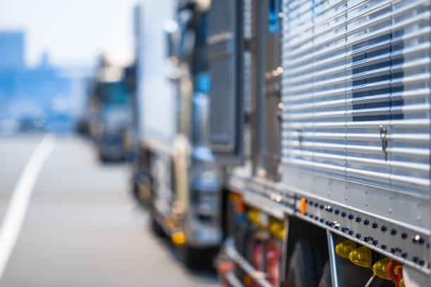 Detail view to blurred row of trucks at roadside (copy space)