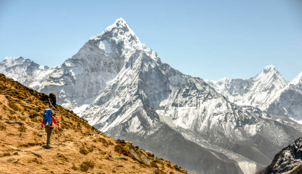 istock Female hiker follows trail along mountain ridge 1388531050