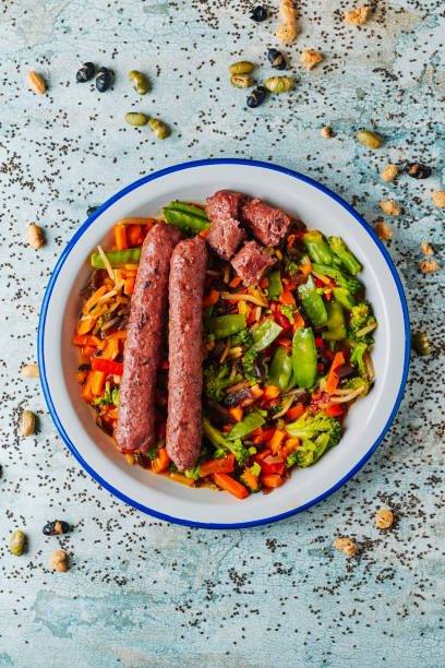 plate with grilled veggie sausages and vegetables