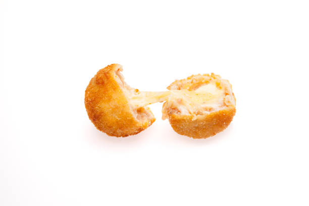 Breaded chicken meat balls with oozing stretchy mozzarella cheese isolated on a white background. Breaded chicken meat balls with oozing stretchy mozzarella cheese isolated on a white background. chicken balls stock pictures, royalty-free photos & images