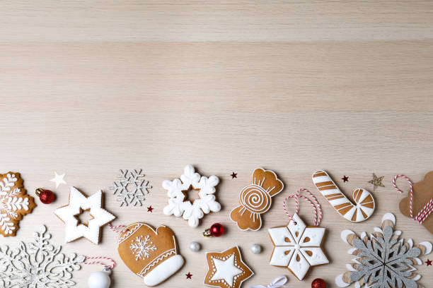istock Decorated Christmas cookies on wooden table, flat lay. Space for text 1388537574