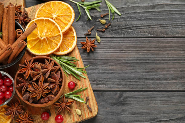 istock Flat lay composition with mulled wine ingredients on black wooden table. Space for text 1388537697