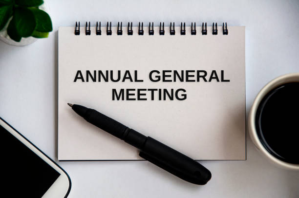istock Annual general meeting text on notepad with office concept background. Conceptual 1388538004