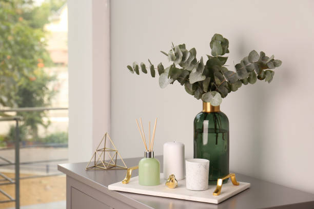 istock Composition with eucalyptus branches in vase on chest of drawers indoors. Interior design 1388539144