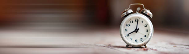 istock Vintage alarm clock on wood shelf 1388539370